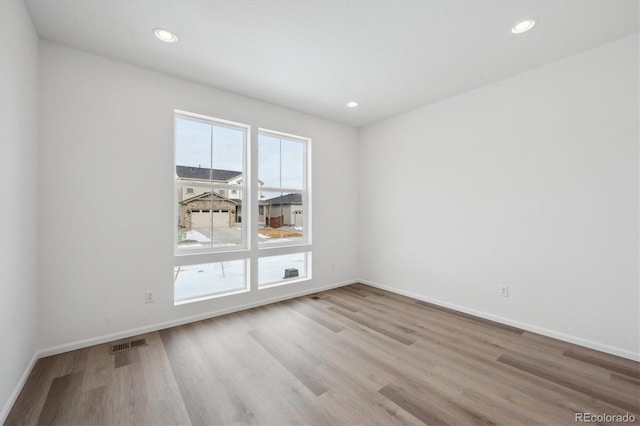 spare room with a healthy amount of sunlight and light wood-type flooring