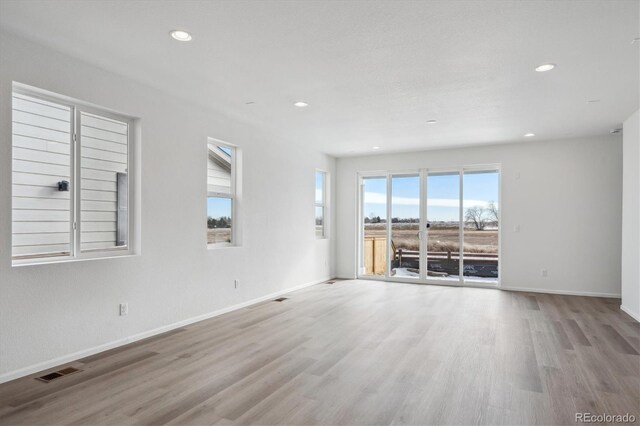 spare room with light wood-type flooring