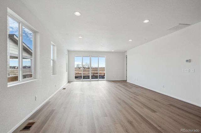 unfurnished living room with light wood-type flooring