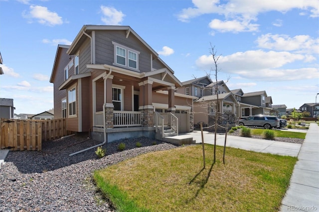 view of front of home with covered porch, concrete driveway, a garage, a residential view, and stone siding