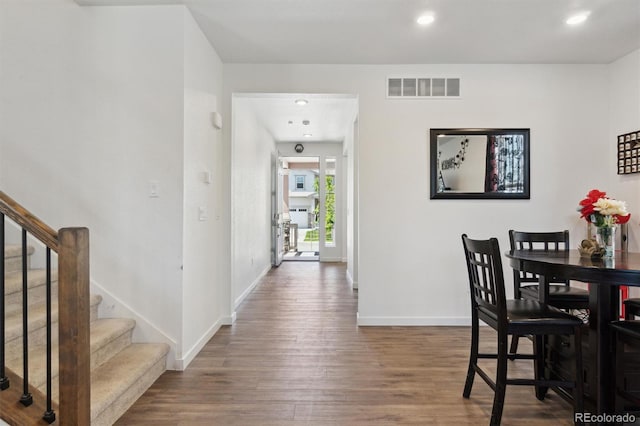 dining area with wood finished floors, stairway, baseboards, and recessed lighting