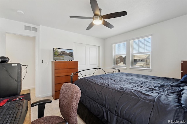 bedroom featuring light carpet, a closet, ceiling fan, and baseboards