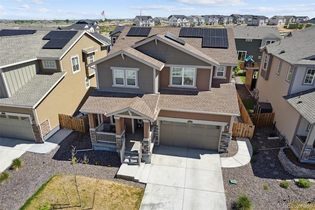 view of front of home featuring a shingled roof, a porch, a residential view, driveway, and an attached garage