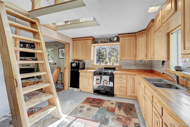 205 Ohler Ct, Jefferson, CO 80456 - kitchen featuring black appliances, a sink, light brown cabinets, light tile patterned floors, and butcher block counters