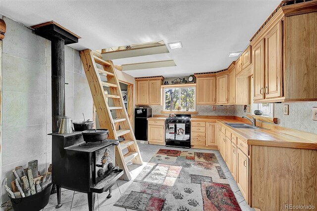 205 Ohler Ct, Jefferson, CO 80456 - kitchen featuring black appliances, light brown cabinets, open shelves, and a sink