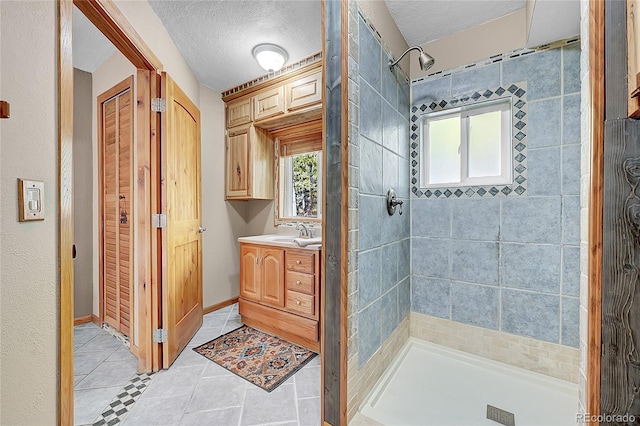 205 Ohler Ct, Jefferson, CO 80456 - bathroom featuring a shower stall, tile patterned floors, vanity, and a textured ceiling