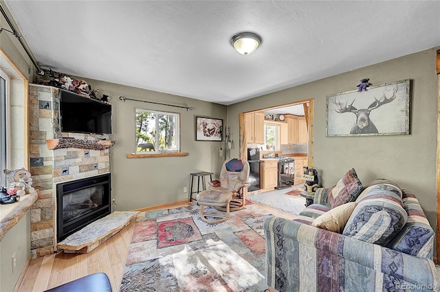 205 Ohler Ct, Jefferson, CO 80456 - living room with a fireplace, baseboards, and a textured ceiling