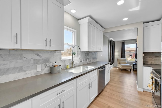 kitchen featuring white cabinetry, sink, light wood-type flooring, and plenty of natural light