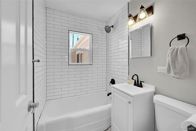 full bathroom with vanity, tiled shower / bath combo, and toilet