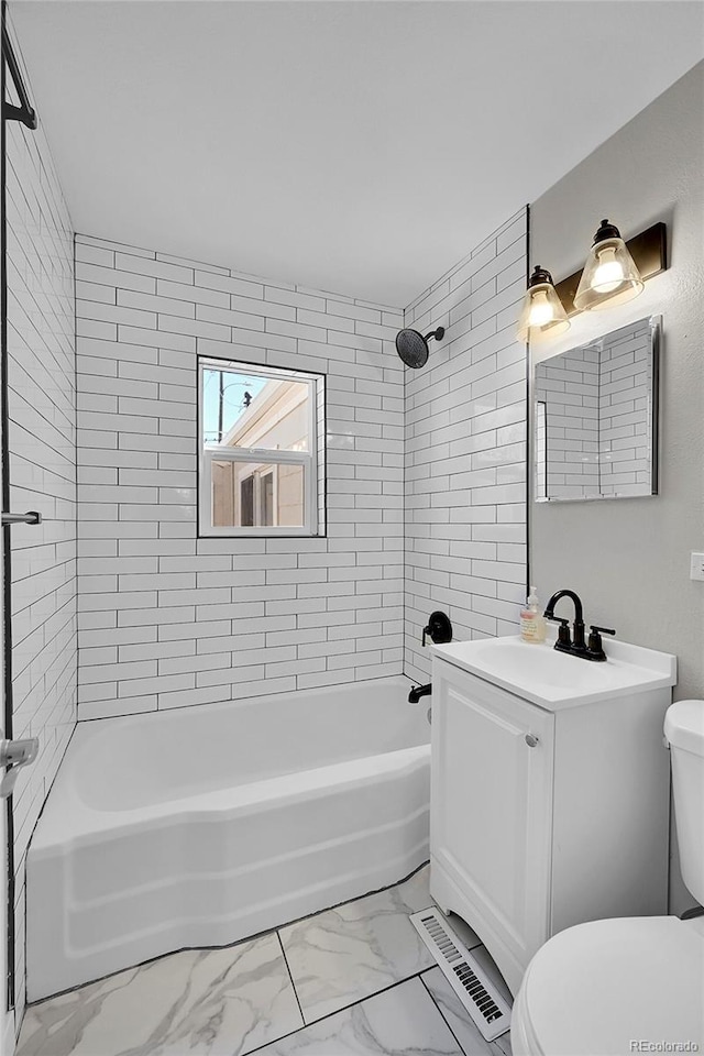 full bathroom featuring toilet, tile floors, tiled shower / bath combo, and vanity