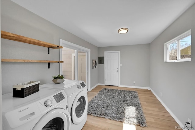 laundry area with light hardwood / wood-style flooring and independent washer and dryer