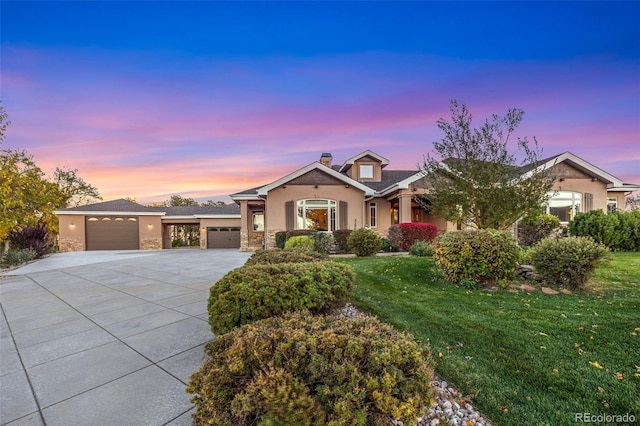 craftsman-style house featuring a garage and a lawn