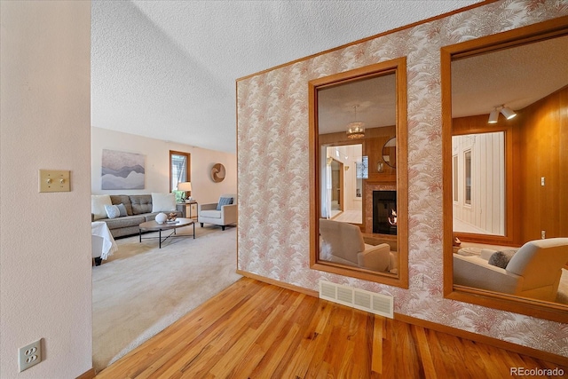 31 Irene Ct, Broomfield, CO 80020 - hall with a textured ceiling, wallpapered walls, wood finished floors, and baseboards