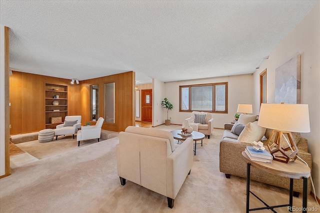 31 Irene Ct, Broomfield, CO 80020 - living room featuring a textured ceiling, wood walls, built in features, light carpet, and baseboards