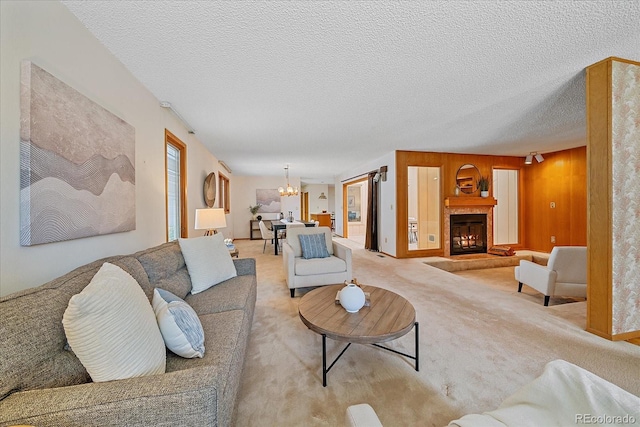 31 Irene Ct, Broomfield, CO 80020 - carpeted living room with a chandelier, a fireplace with raised hearth, and a textured ceiling