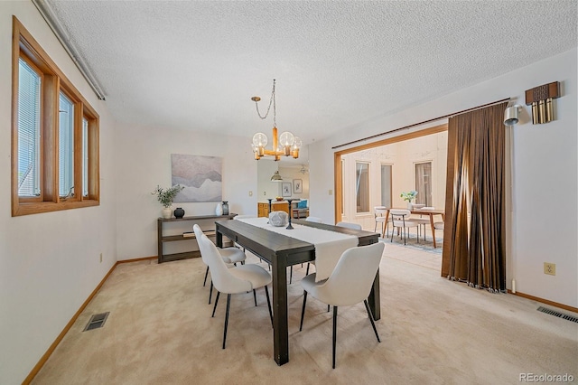 31 Irene Ct, Broomfield, CO 80020 - dining space with light colored carpet, a textured ceiling, a chandelier, and baseboards