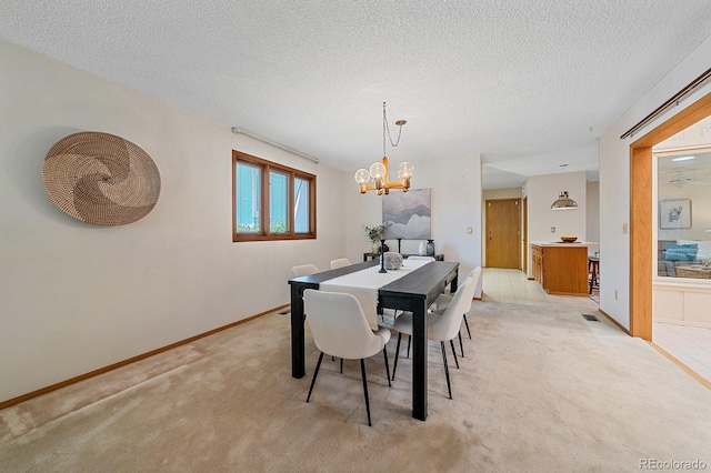 31 Irene Ct, Broomfield, CO 80020 - dining space featuring light carpet, a chandelier, a textured ceiling, and baseboards