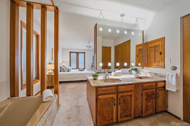 31 Irene Ct, Broomfield, CO 80020 - full bathroom with double vanity, ceiling fan, ensuite bathroom, a textured ceiling, and a tub to relax in
