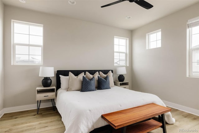 bedroom with light wood-type flooring, baseboards, recessed lighting, and a ceiling fan