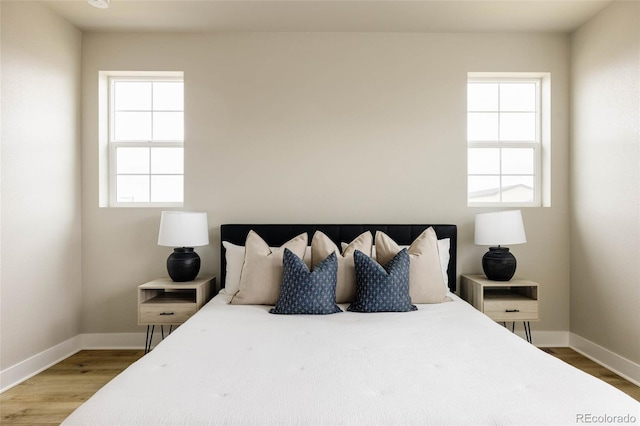 bedroom featuring wood finished floors and baseboards