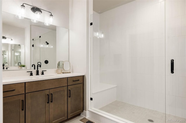 full bathroom featuring a shower stall and vanity