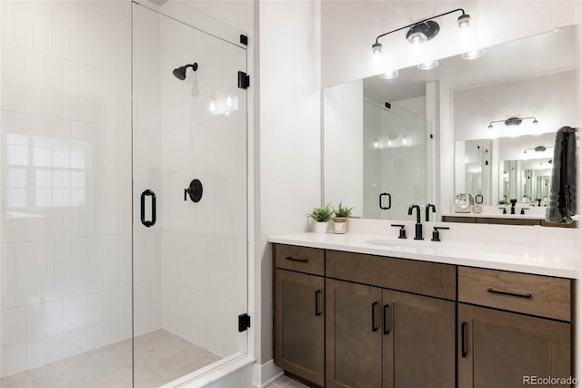 bathroom featuring a stall shower and vanity
