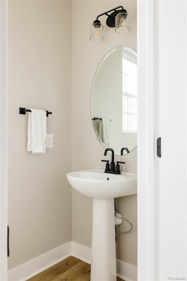 bathroom featuring baseboards and wood finished floors