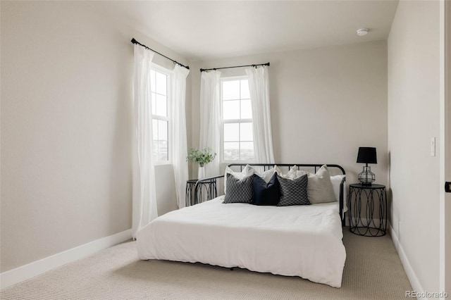 carpeted bedroom featuring baseboards