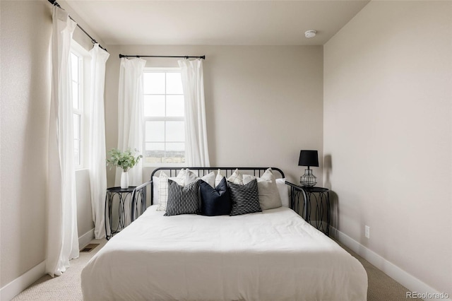bedroom with carpet and baseboards