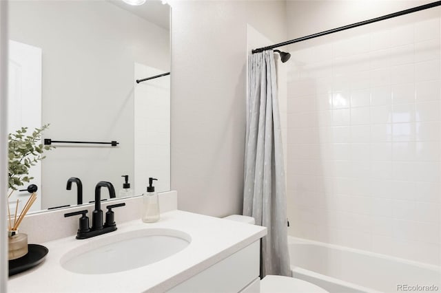 bathroom featuring shower / bath combo, toilet, and vanity