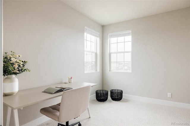 carpeted home office featuring baseboards