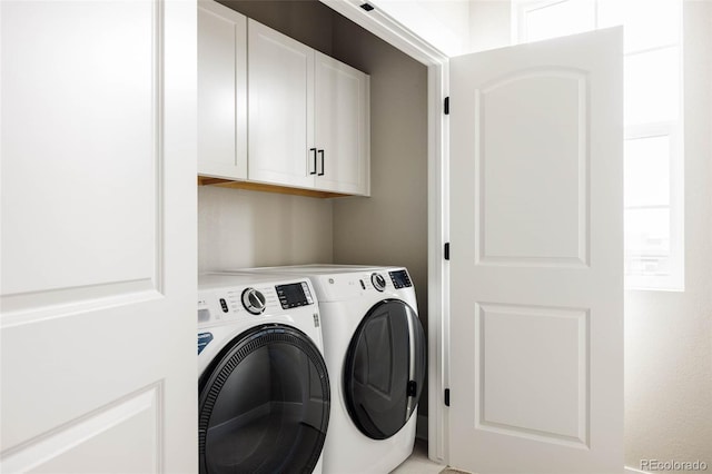 laundry room featuring cabinet space and separate washer and dryer