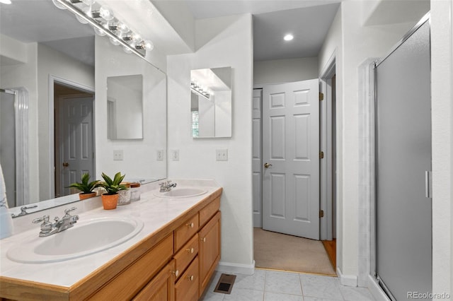 12502 E Harvard Cir, Aurora, CO 80014 - bathroom with double vanity, a stall shower, and tile patterned flooring