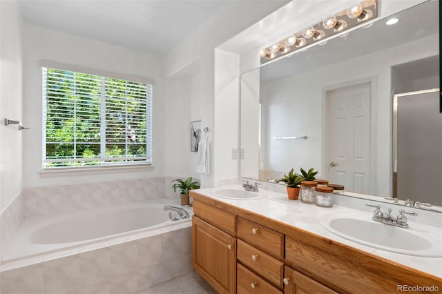 12502 E Harvard Cir, Aurora, CO 80014 - full bath featuring double vanity, a bath, a stall shower, and tile patterned floors