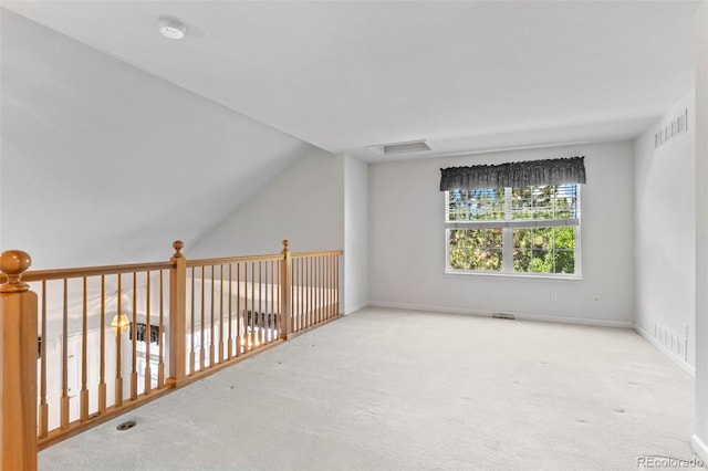12502 E Harvard Cir, Aurora, CO 80014 - spare room featuring a smoke detector, carpet floors, and vaulted ceiling