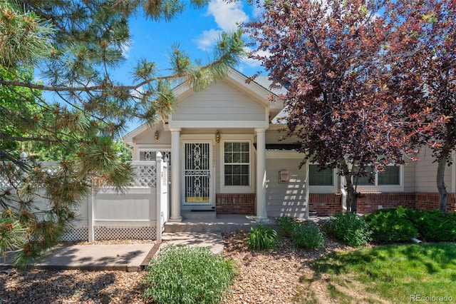 12502 E Harvard Cir, Aurora, CO 80014 - view of front facade with brick siding and a porch