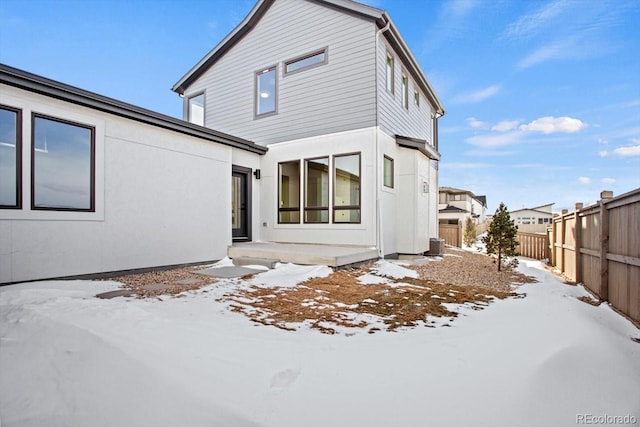 view of snow covered back of property