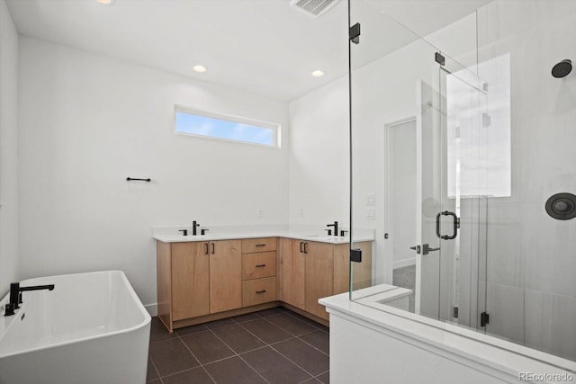 bathroom with tile patterned flooring, vanity, and shower with separate bathtub