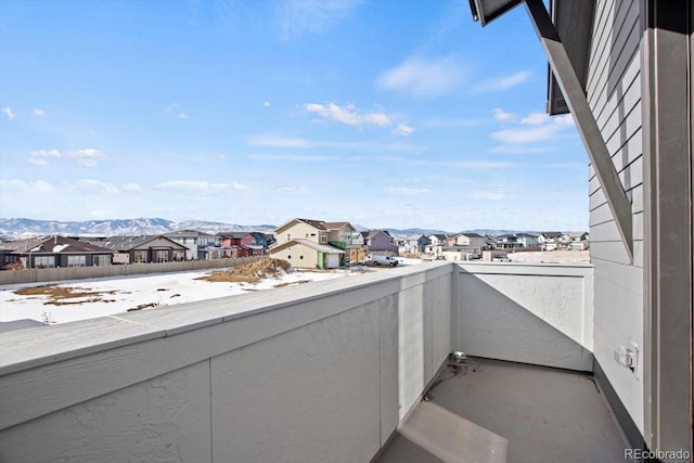 snow covered back of property featuring a mountain view