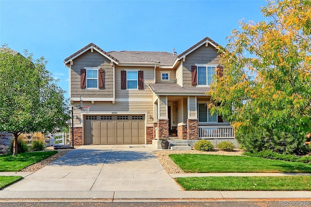 craftsman house with a front yard, a porch, and a garage