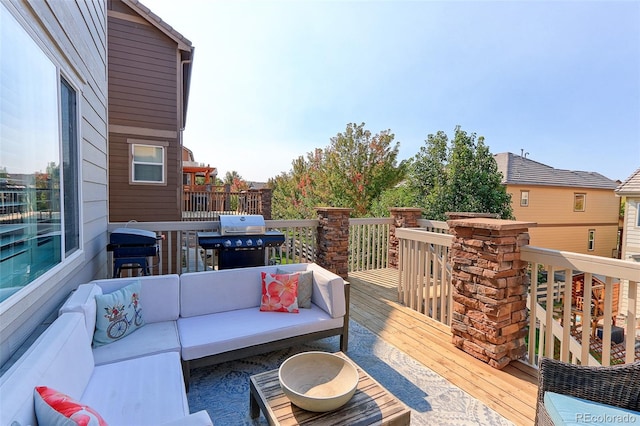 deck featuring outdoor lounge area and grilling area