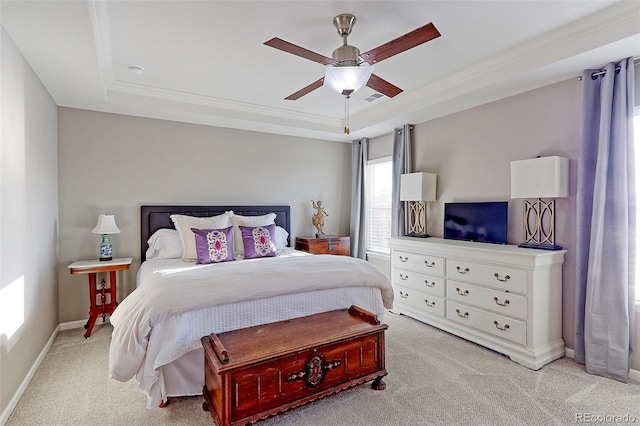 bedroom featuring light carpet, ornamental molding, a raised ceiling, and ceiling fan