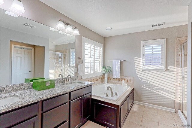 bathroom with vanity, independent shower and bath, and tile patterned floors