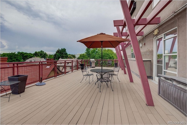 1488 Madison St Unit 211, Denver, CO 80206 - wooden terrace featuring outdoor dining space, a grill, and radiator heating unit