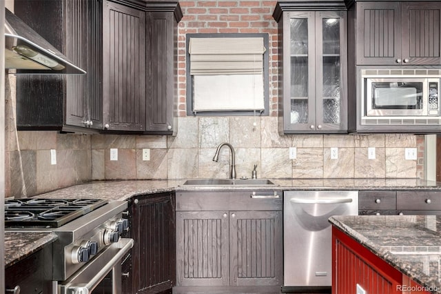 210 W Magnolia St Unit 360, Fort Collins, CO 80521 - kitchen with appliances with stainless steel finishes, a sink, wall chimney range hood, tasteful backsplash, and glass insert cabinets