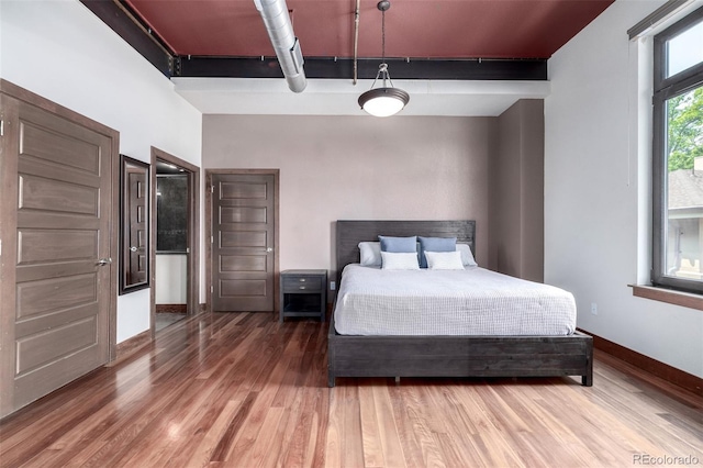 210 W Magnolia St Unit 360, Fort Collins, CO 80521 - bedroom featuring wood finished floors and baseboards