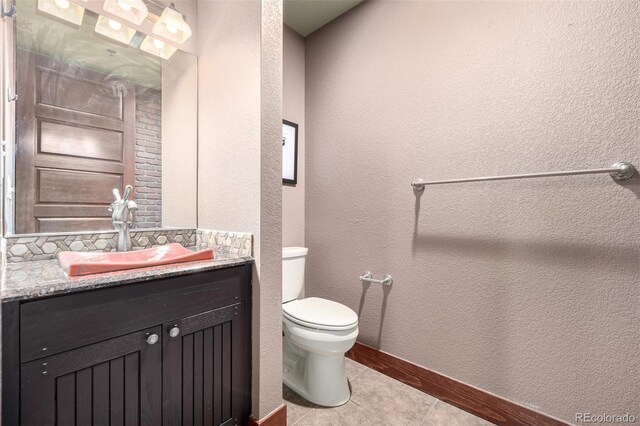 210 W Magnolia St Unit 360, Fort Collins, CO 80521 - bathroom with vanity, toilet, baseboards, tile patterned floors, and a textured wall