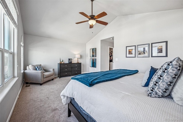 carpeted bedroom with high vaulted ceiling, ceiling fan, and baseboards