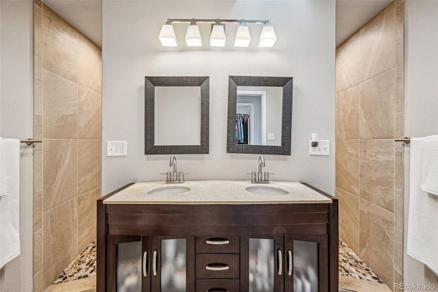 full bathroom with double vanity and a sink