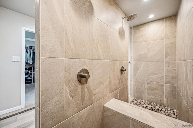 bathroom featuring a tile shower and recessed lighting